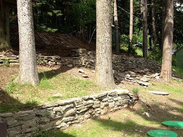 Stone retaining wall with septic tank access